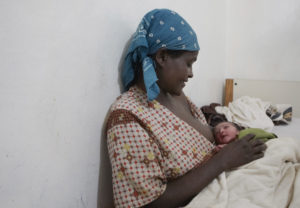 Woman holds newborn.